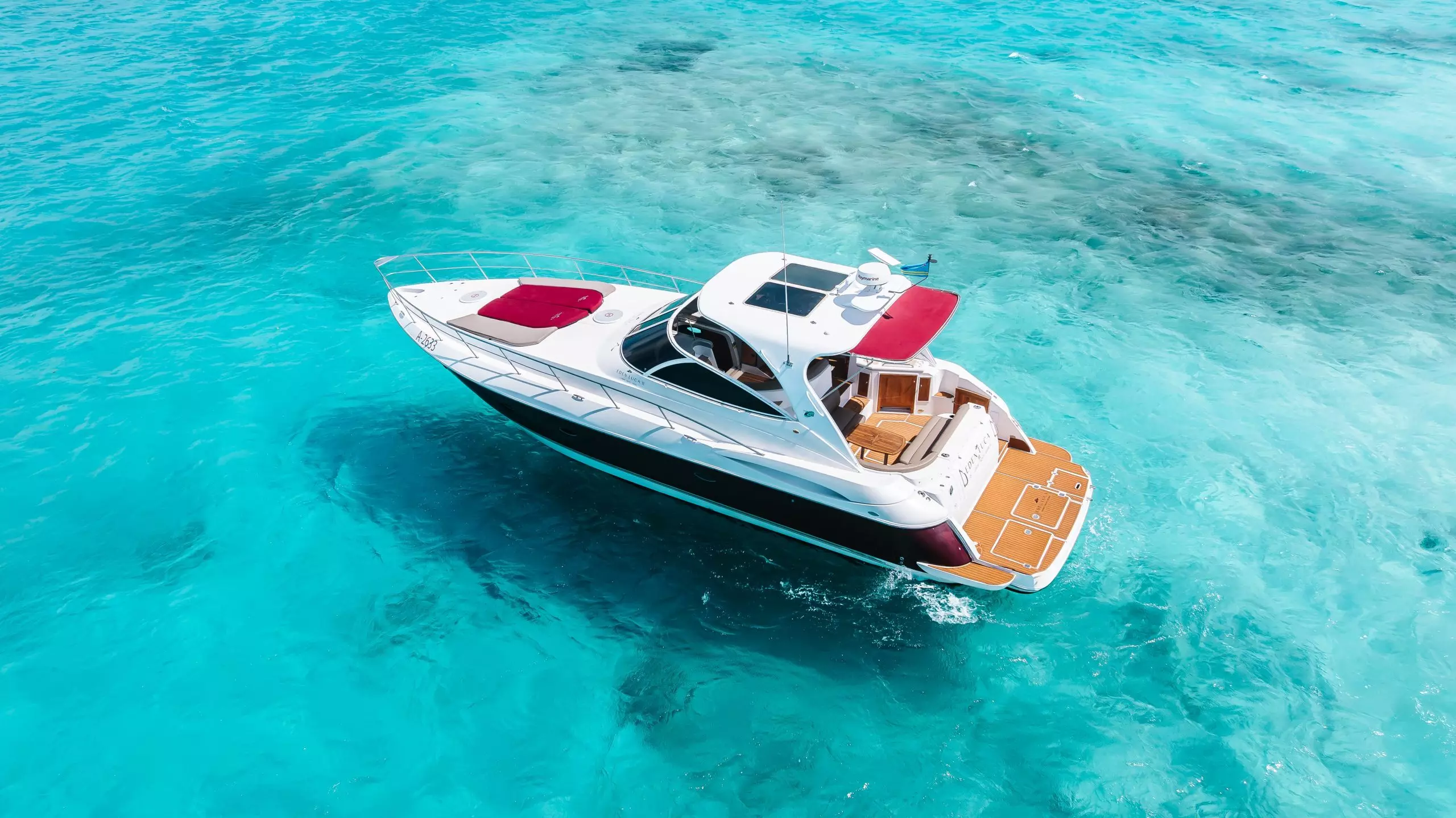 Aerial view of a 47-foot private luxury yacht charter in the turquoise waters of Aruba
