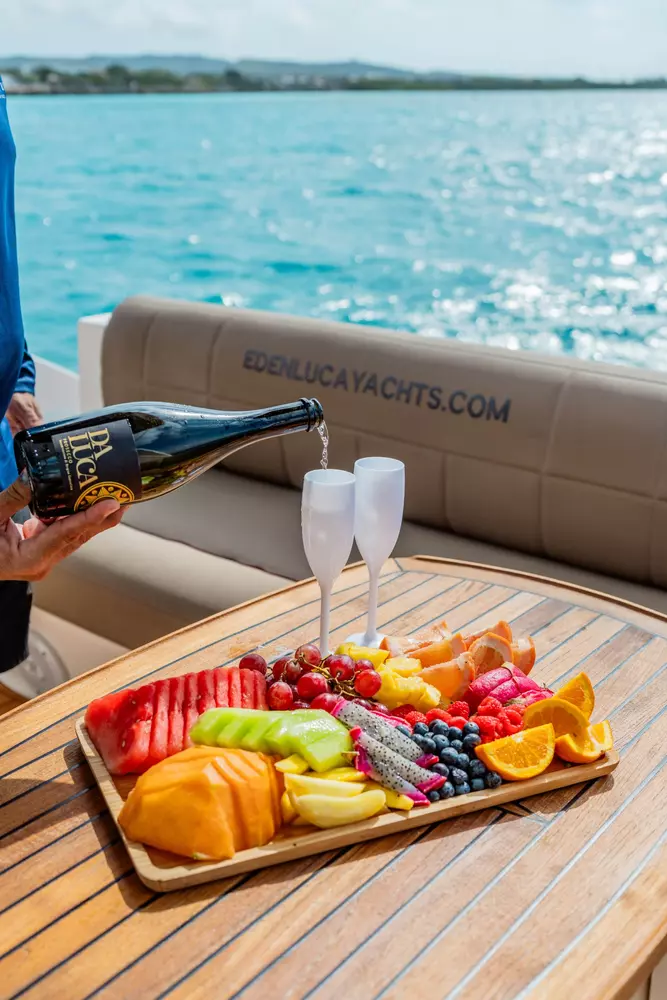 Fresh fruit platter and drinks served aboard a 47-foot private yacht charter in Aruba